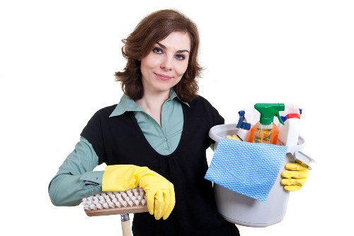 Technician cleaning a sofa with specialist equipment